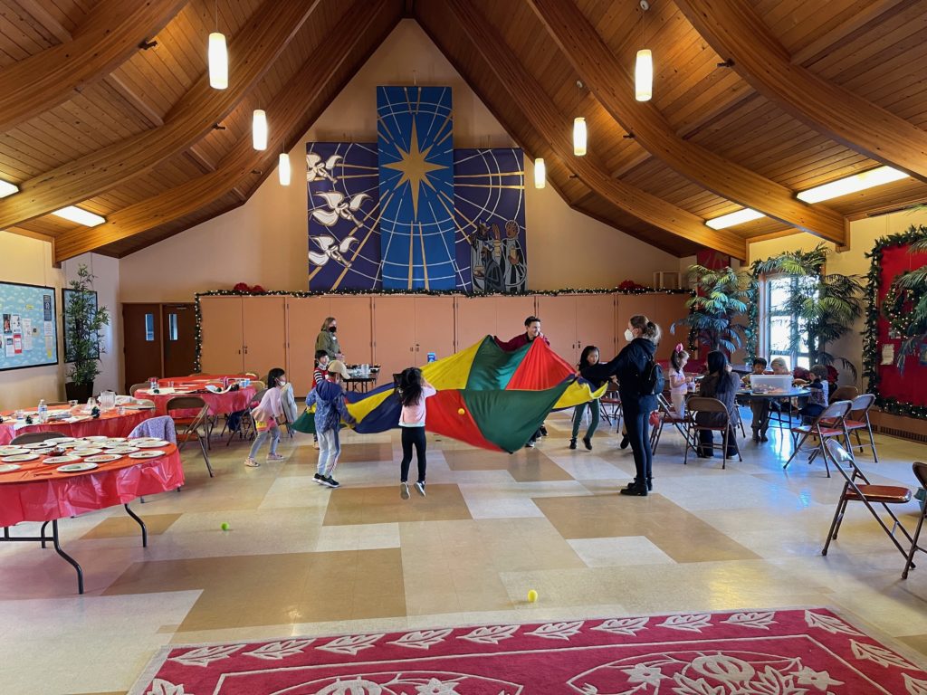 Photo of children playing with parachute in Parish Hall